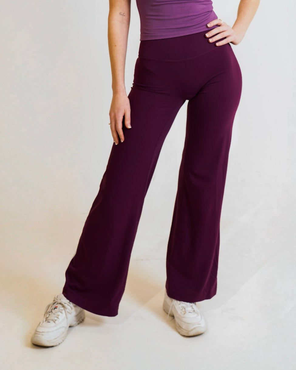 Woman wearing a purple athletic outfit on a white background