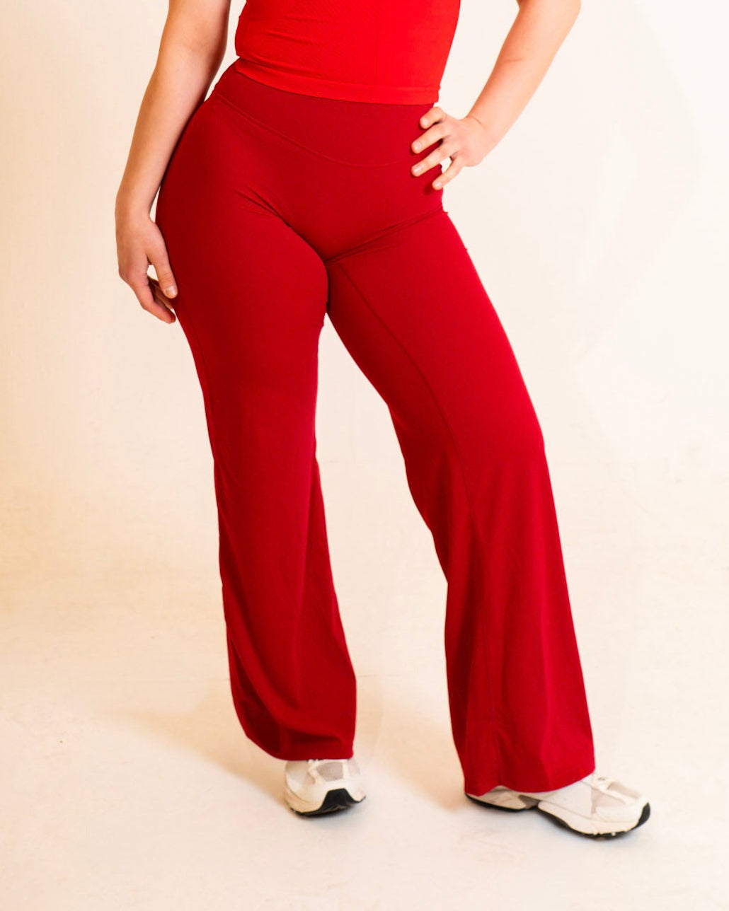 Woman wearing a red outfit against a plain background